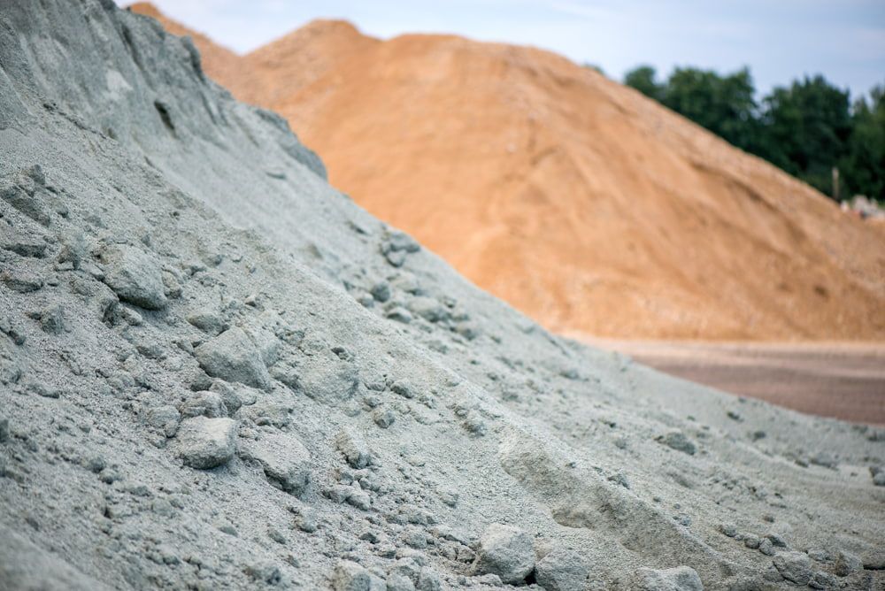 There Are Many Piles of Dirt and Sand in The Background — BVN Landscape and Concrete Supplies in St Georges Basin, NSW