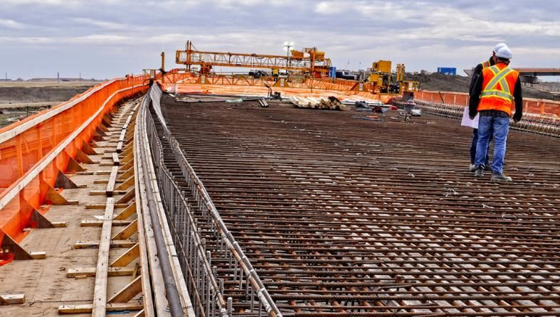 A Construction Worker Is Walking on A Bridge Under Construction — BVN Landscape and Concrete Supplies in  Nowra, NSW