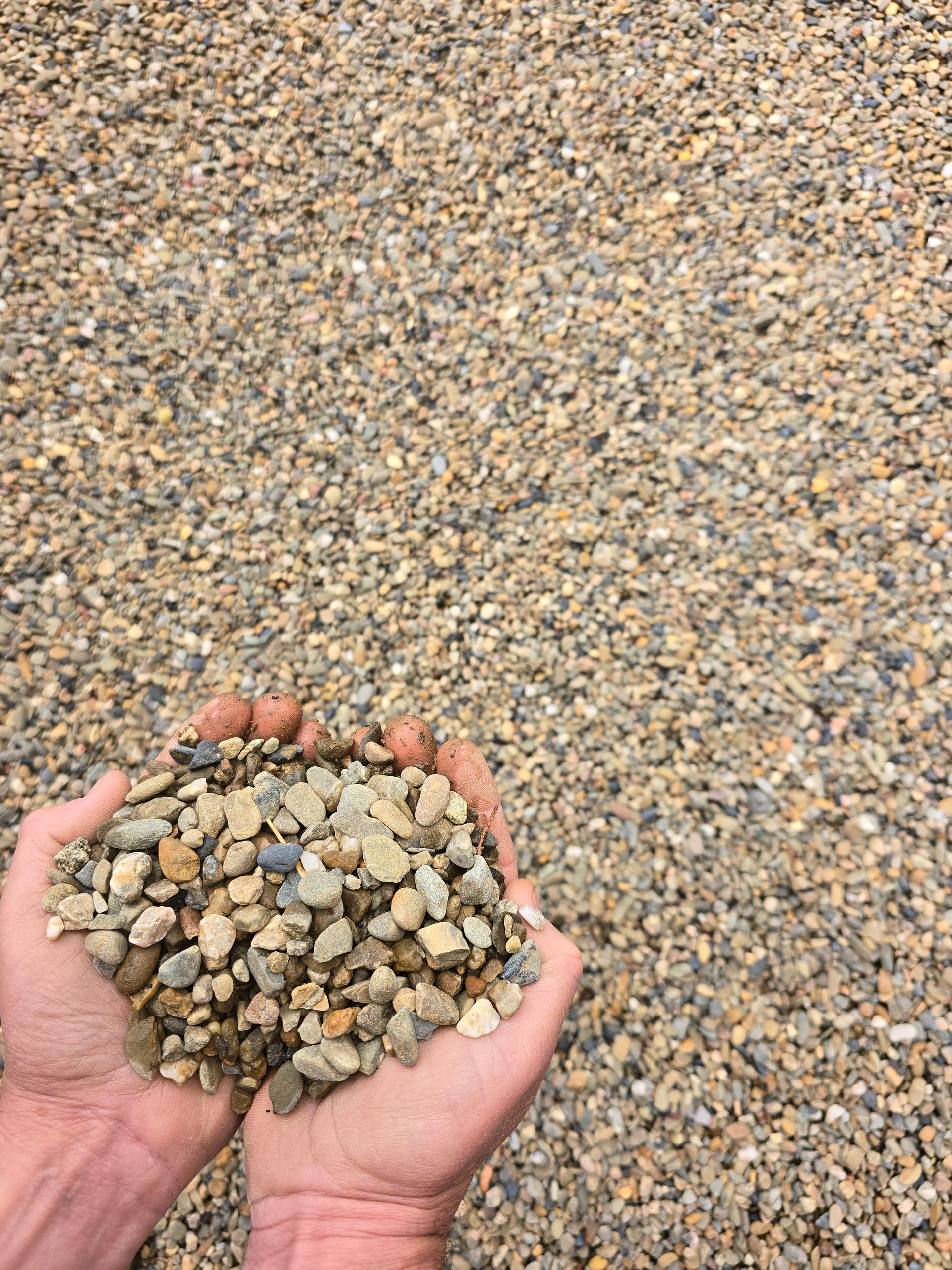 Hands Holding a Pile of Small, Light-coloured Gravel — BVN Landscape and Concrete Supplies in St Georges Basin, NSW