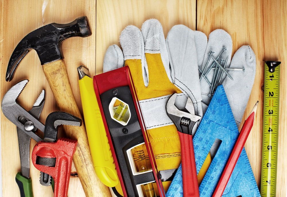 A Bunch of Tools Are Sitting on A Wooden Table — BVN Landscape and Concrete Supplies in St Georges Basin, NSW