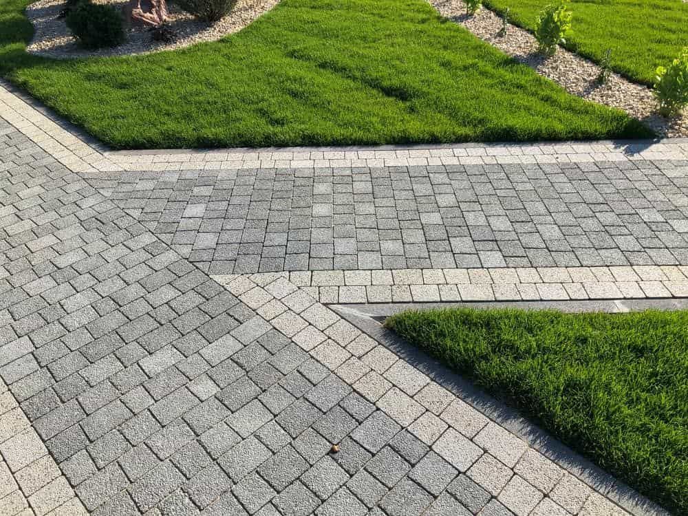 A Brick Walkway Leading to A Lush Green Lawn — BVN Landscape and Concrete Supplies in St Georges Basin, NSW