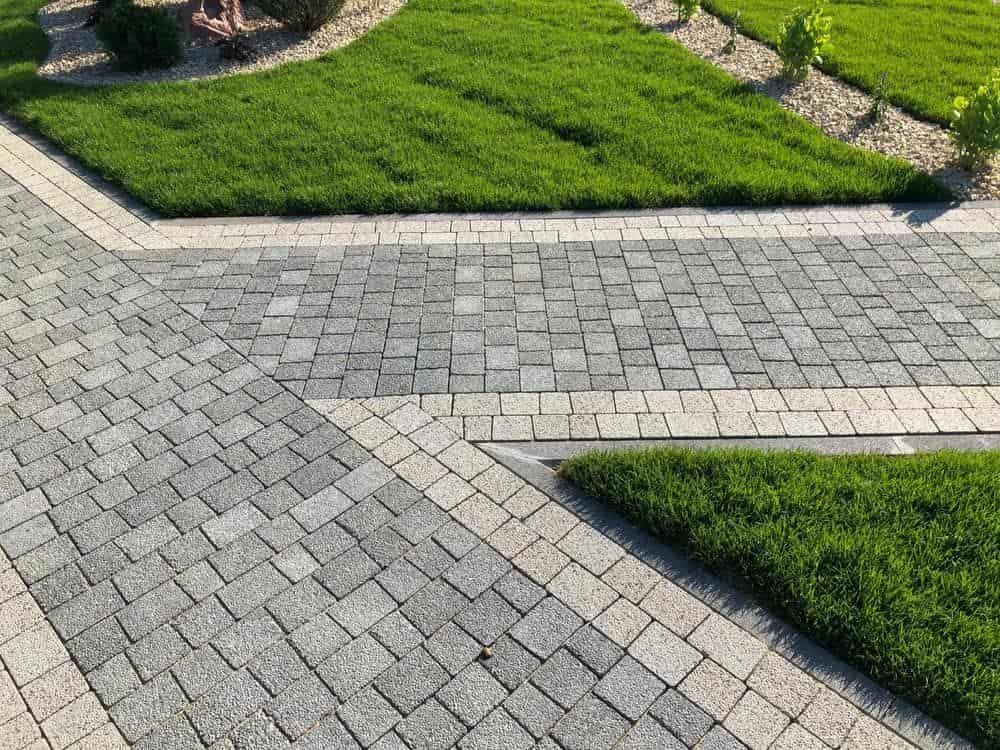 A Brick Walkway Leading to A Lush Green Lawn — BVN Landscape and Concrete Supplies in St Georges Basin, NSW