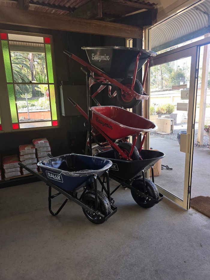 Two Wheelbarrows Are Sitting Next to Each Other in A Room — BVN Landscape and Concrete Supplies in St Georges Basin, NSW