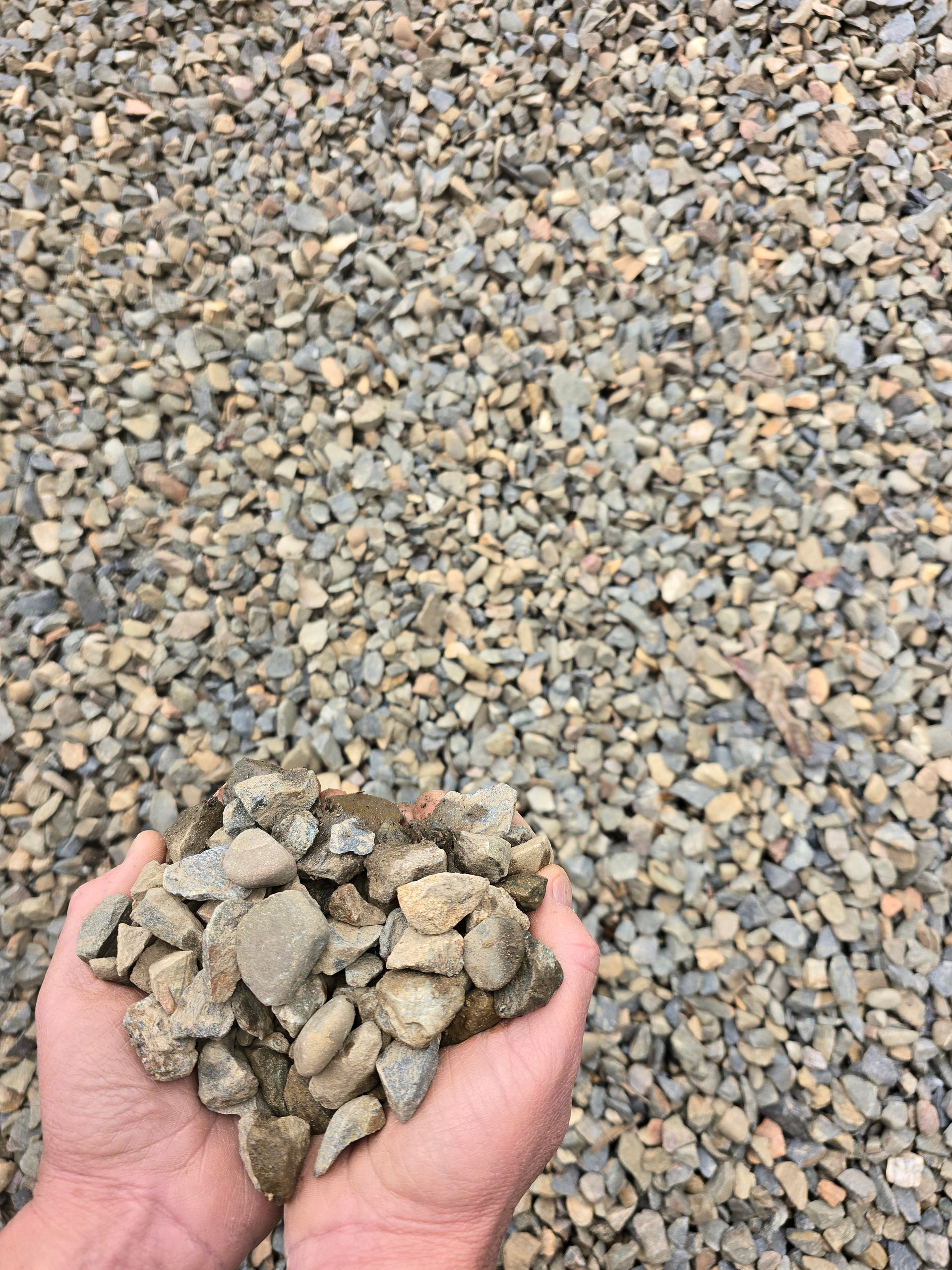 Hands Holding a Pile of Gravel — BVN Landscape and Concrete Supplies in St Georges Basin, NSW