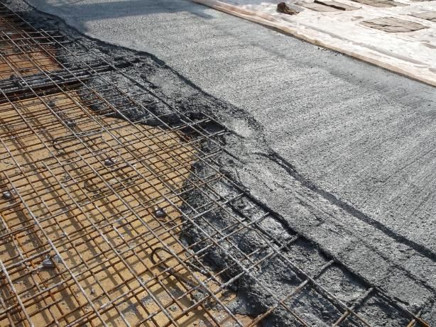 A Concrete Slab Is Being Poured on Top of A Metal Mesh — BVN Landscape and Concrete Supplies in Vincentia, NSW