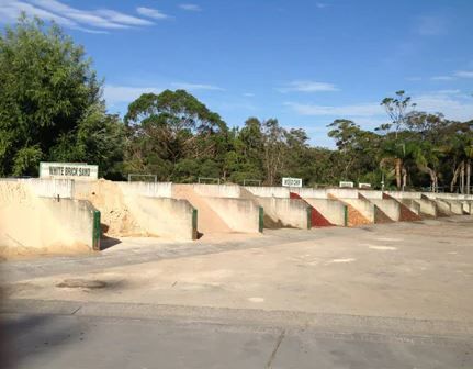 A Row of Concrete Blocks in A Parking Lot with Trees in The Background — BVN Landscape and Concrete Supplies in Nowra, NSW