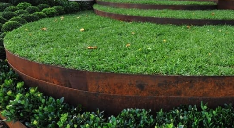 Curved, Weathered Steel Retaining Walls Create Terraced — BVN Landscape and Concrete Supplies in St Georges Basin, NSW