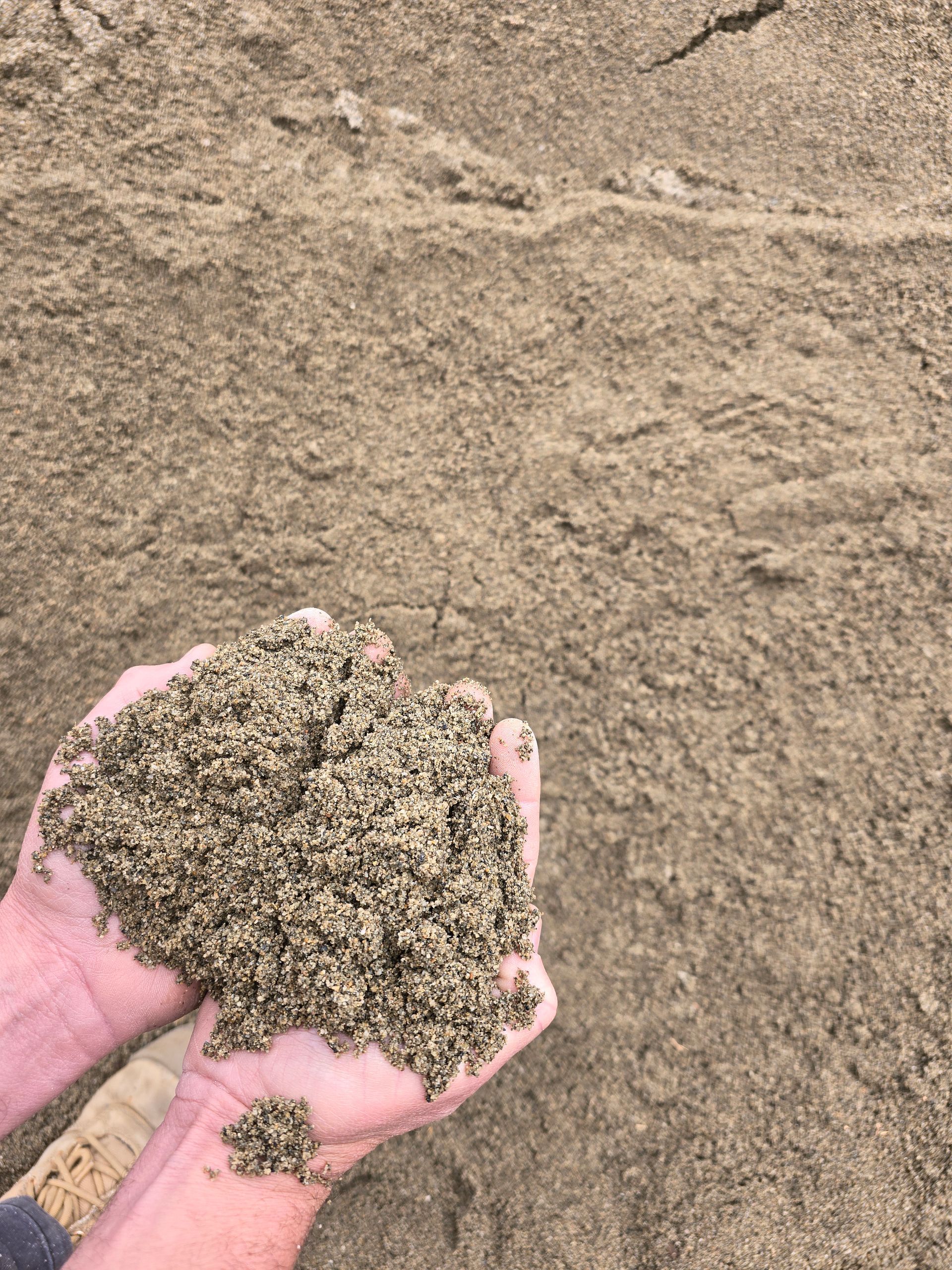 Person Holding a Handful of Sand — BVN Landscape and Concrete Supplies in Sussex Inlet, NSW