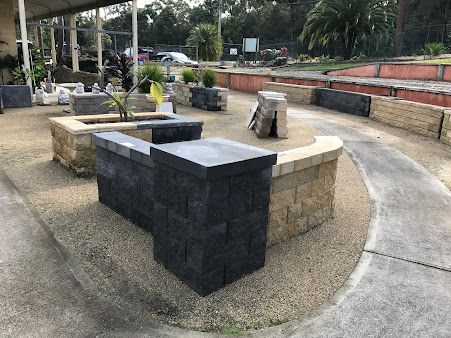 A Brick Wall with A Bench in The Middle of It — BVN Landscape and Concrete Supplies in Nowra, NSW