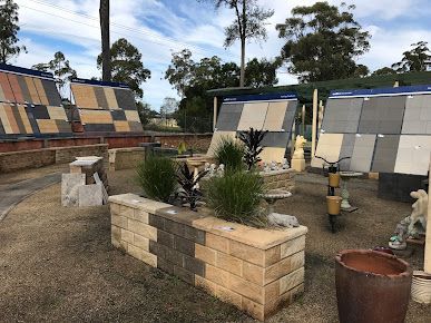 A Display of Tiles and Potted Plants in A Garden — BVN Landscape and Concrete Supplies in Nowra, NSW