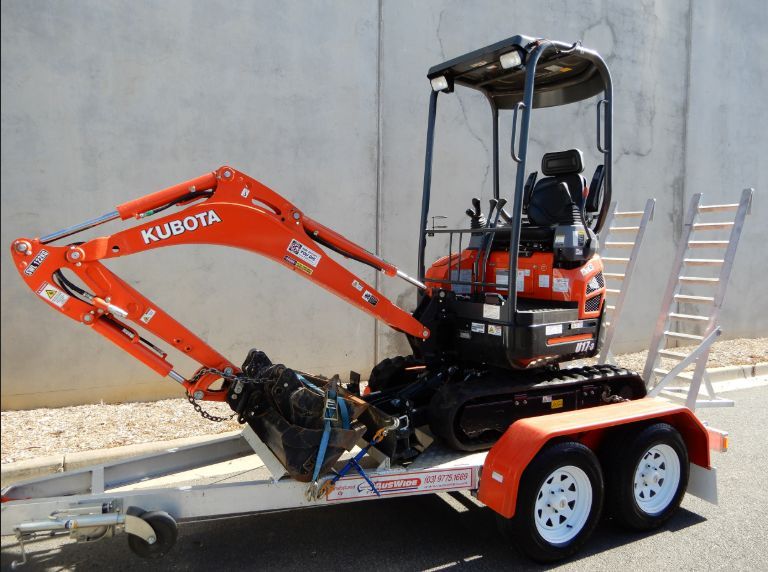 Orange Kubota Mini Excavator on a Trailer, Ready for Transport — BVN Landscape and Concrete Supplies in St Georges Basin, NSW