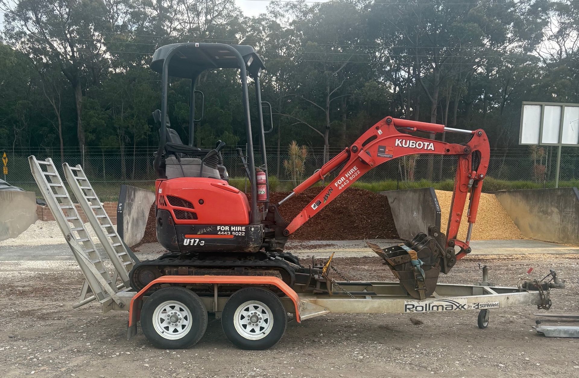 Red Mini Excavator Digging In the Sand — BVN Landscape and Concrete Supplies in St Georges Basin, NSW