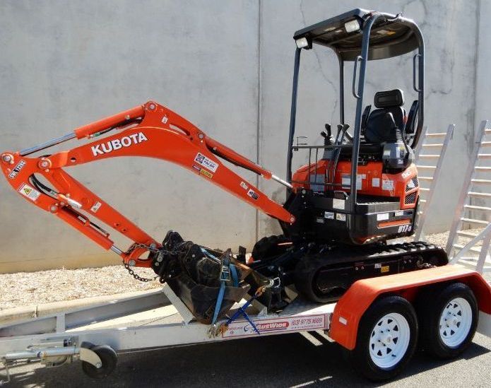Orange Kubota Mini Excavator on a Trailer — BVN Landscape and Concrete Supplies in St Georges Basin, NSW