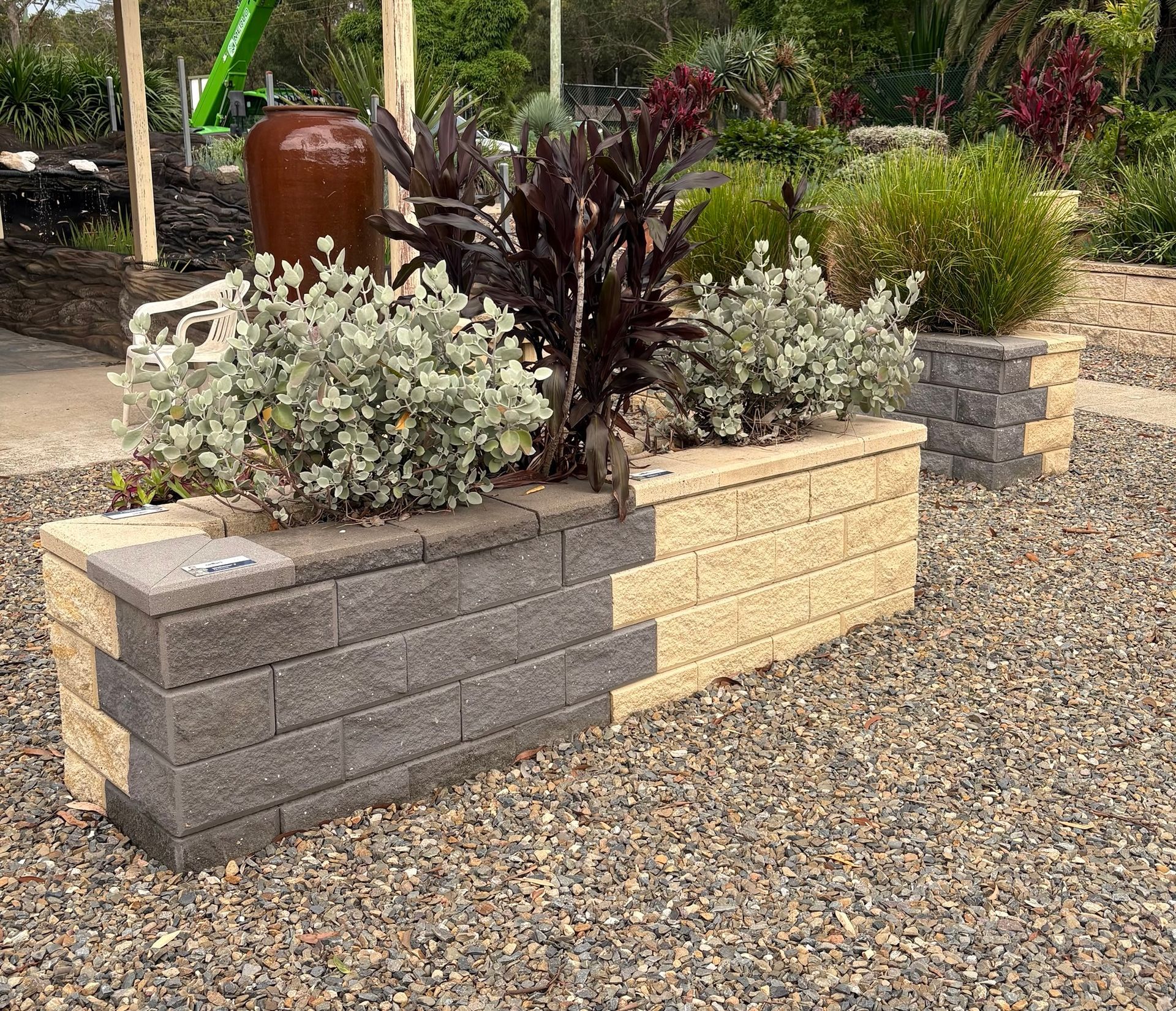 A Small Brick Wall With Plants — BVN Landscape and Concrete Supplies in St Georges Basin, NSW