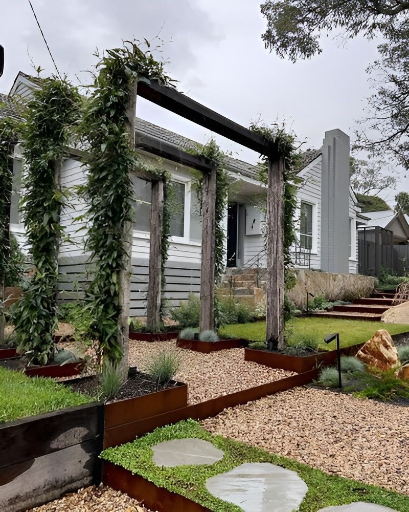 A Modern Front Garden With a Rusted Metal Pergola, Climbing Vines — BVN Landscape and Concrete Supplies in St Georges Basin, NSW