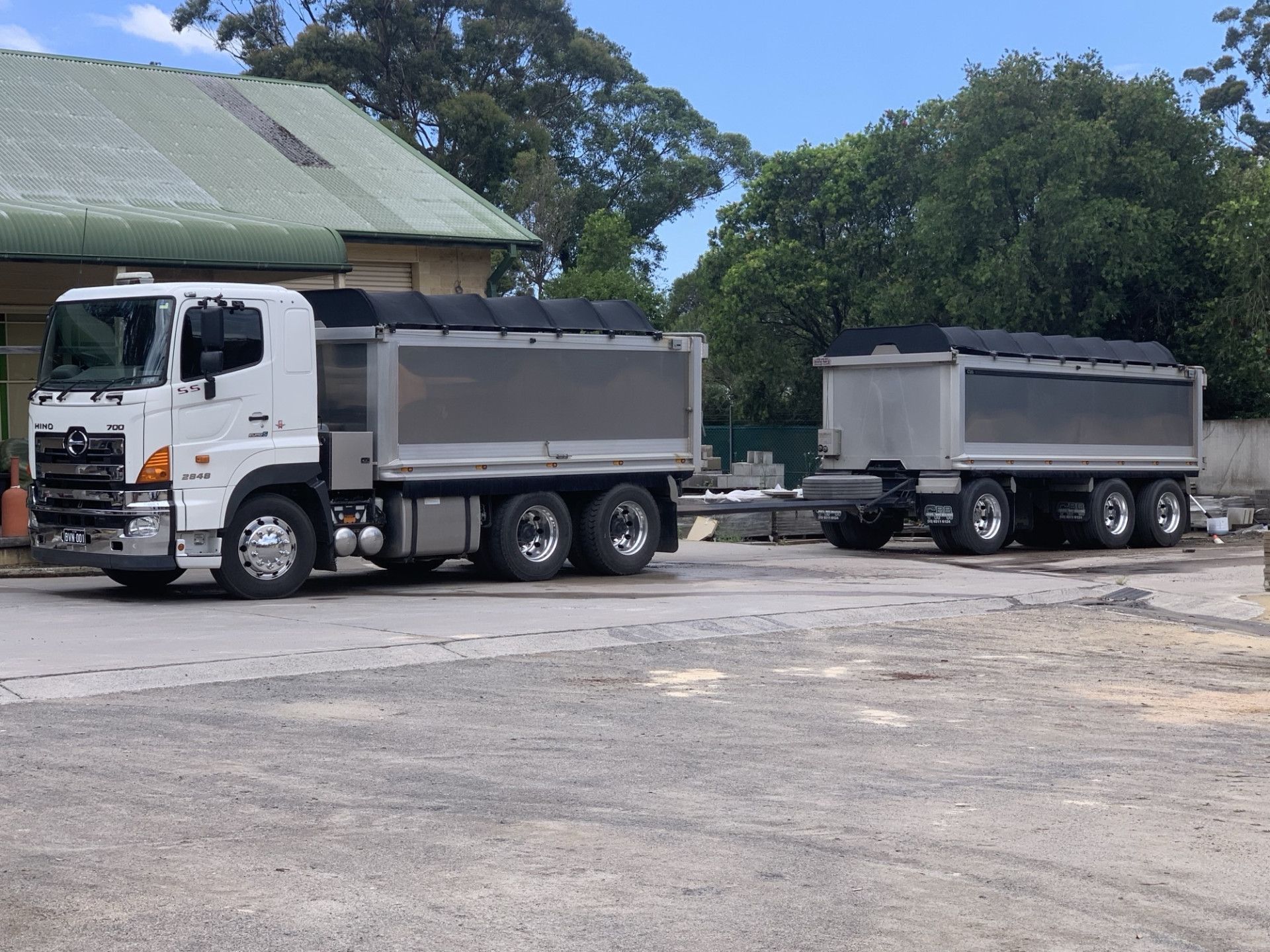 White Dump Truck With Trailer Parked in Front of a Building — BVN Landscape and Concrete Supplies in St Georges Basin, NSW