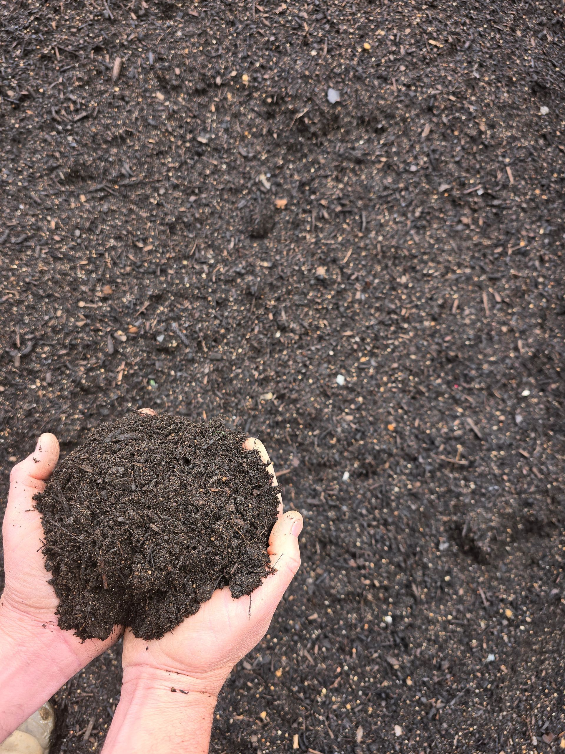 Hands Hold a Dark, Rich Clump of Soil — BVN Landscape and Concrete Supplies in St Georges Basin, NSW