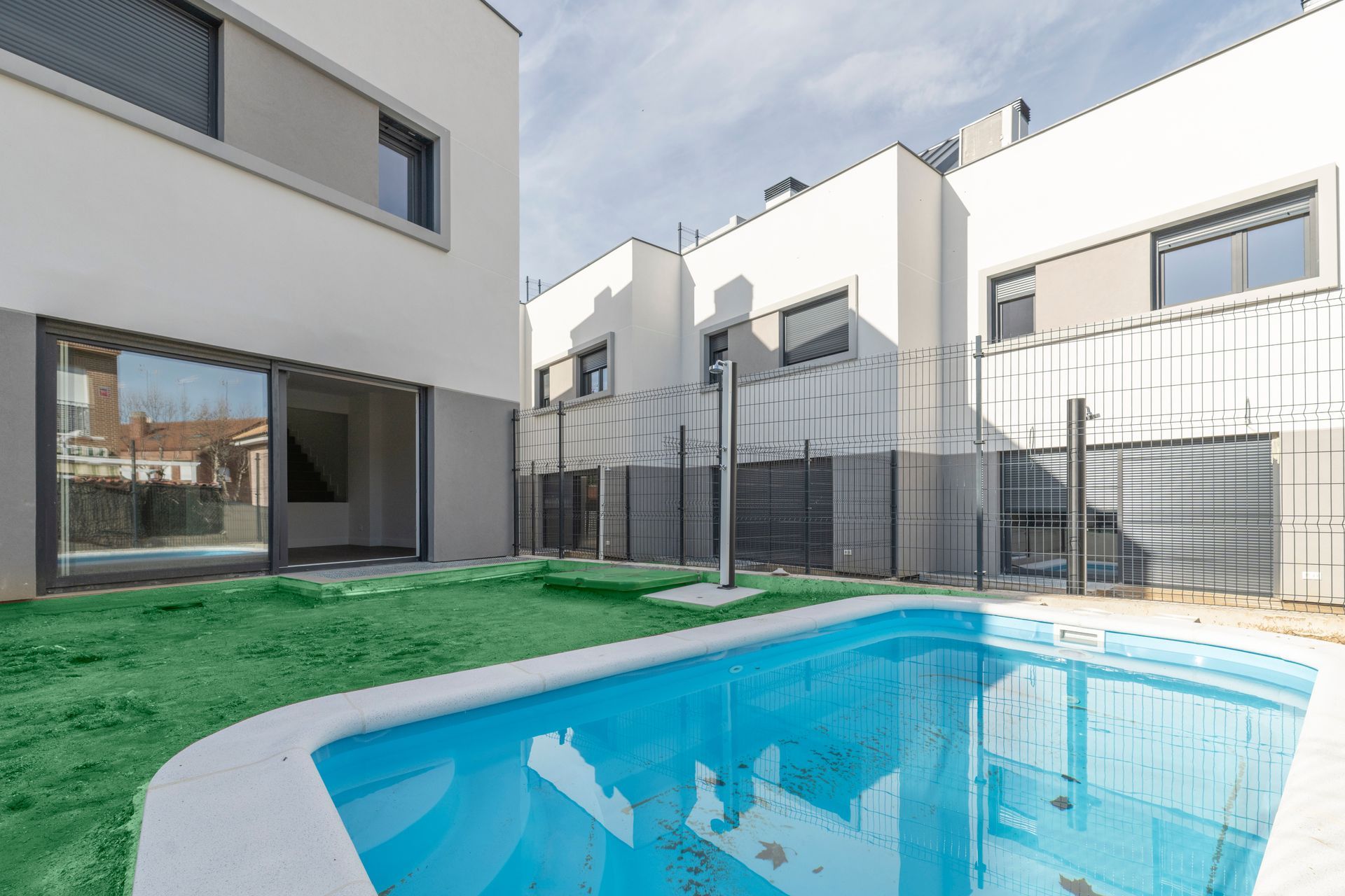 Fenced backyard pool area at a residential home,