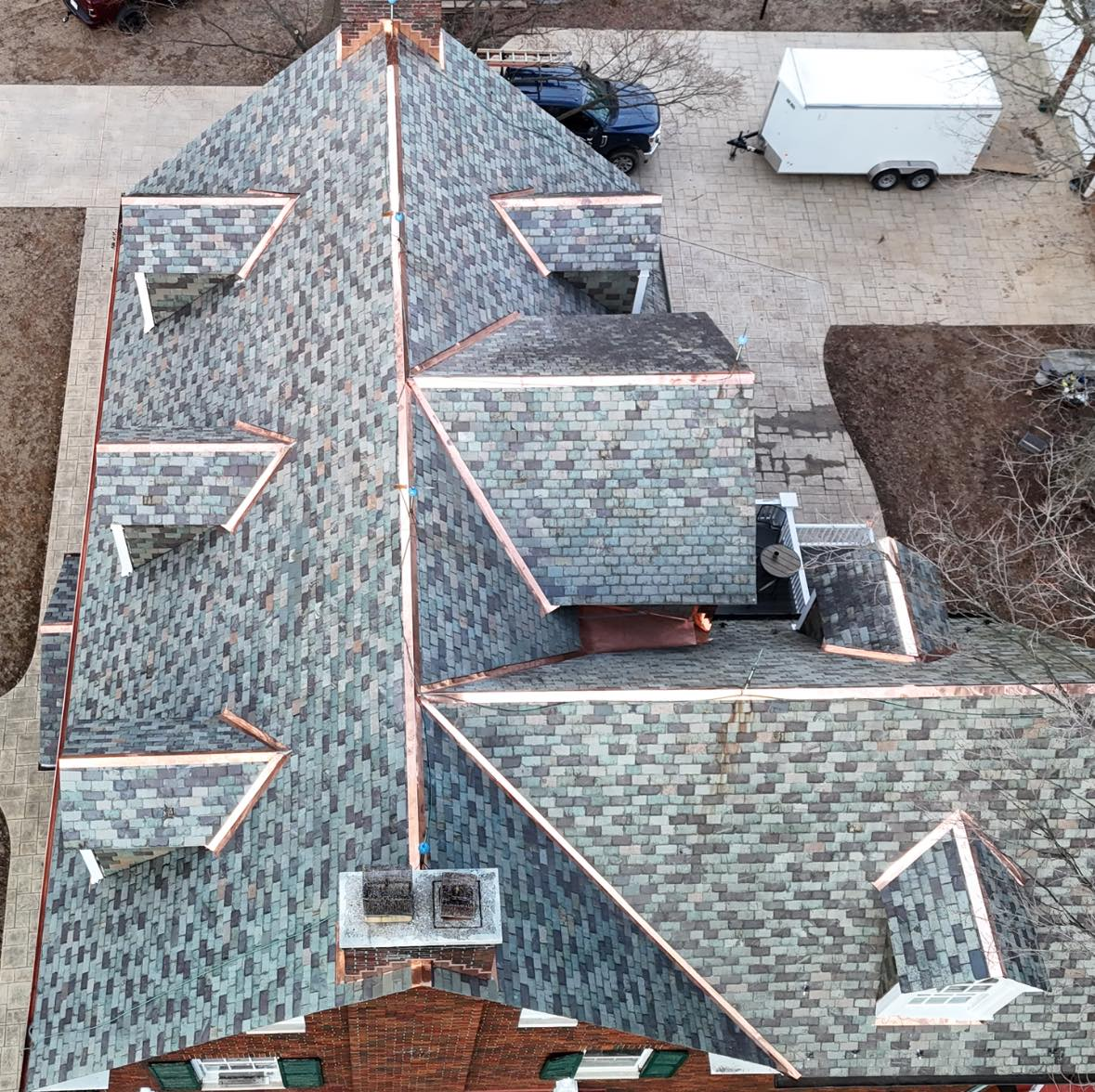 An aerial view of a roof of a house with copper trim.
