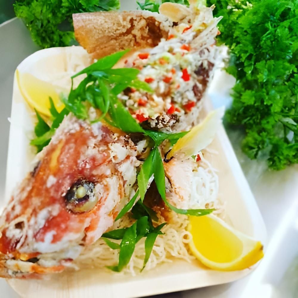 A Plate Of Food With A Fish Head On It — Noosaville Fish Market In Tewantin, QLD