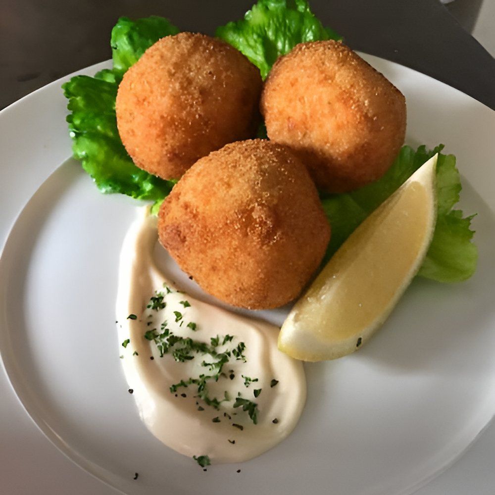 A White Plate Topped With Fried Food And A Slice Of Lemon — Noosaville Fish Market In Tewantin, QLD