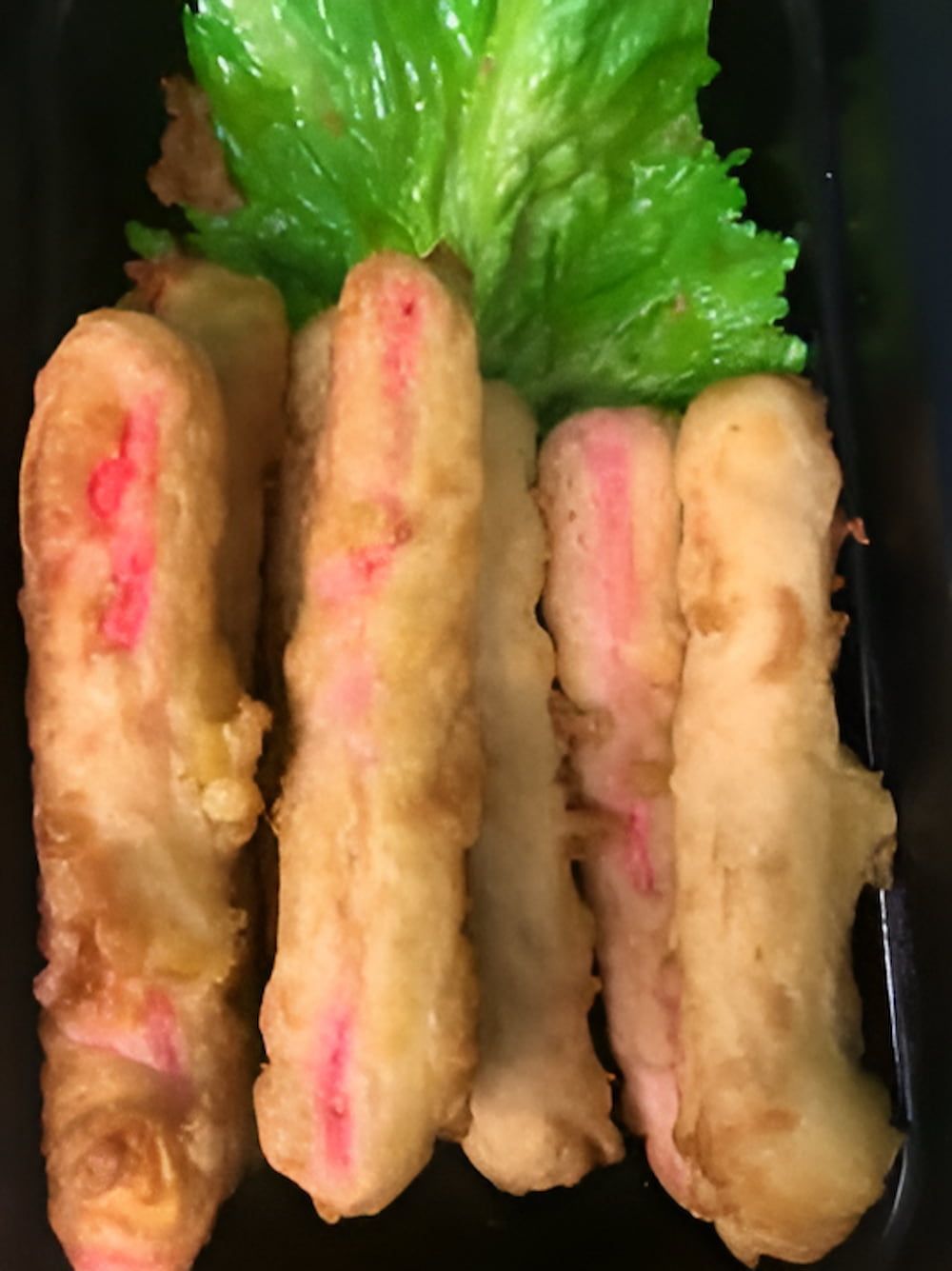 A Close Up Of A Plate Of Food With Lettuce On Top — Noosaville Fish Market In Tewantin, QLD