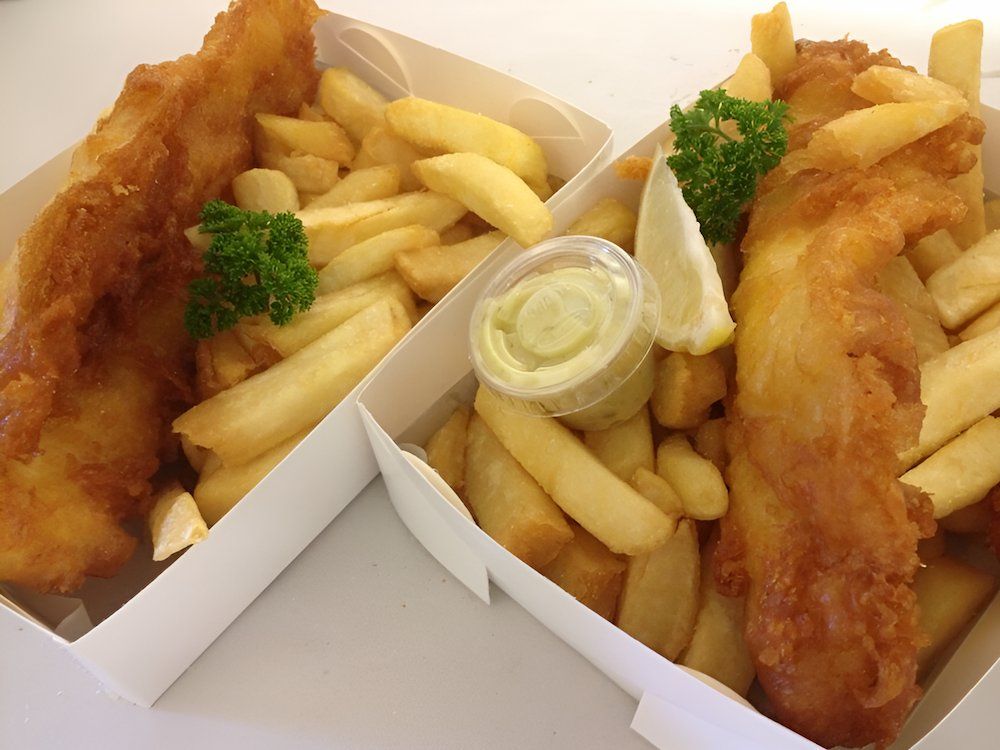 Two Boxes Of Fish And Chips With Dipping Sauce On A Table — Noosaville Fish Market In Tewantin, QLD
