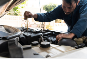 mobile auto repairman changing oil at clients house in Cheyenne.