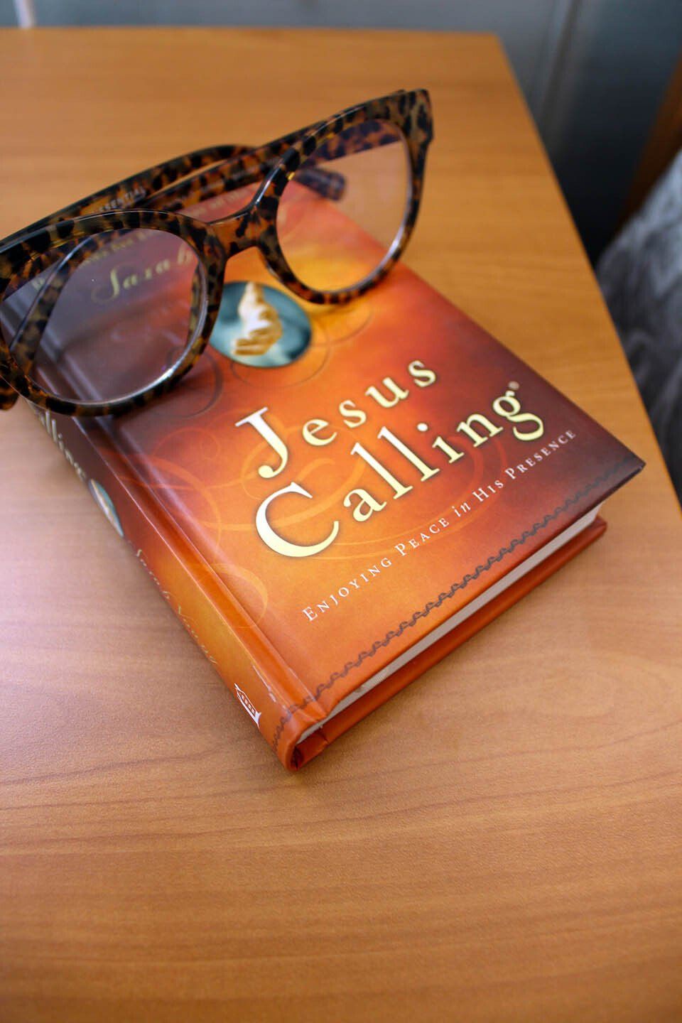 A pair of glasses sits on top of a book called jesus calling
