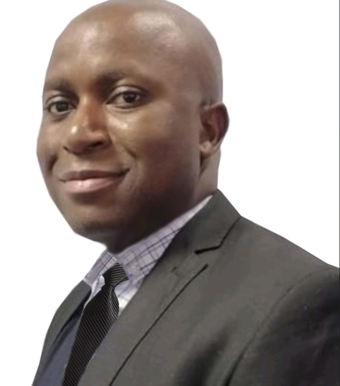 A man in a suit and tie is smiling for the camera