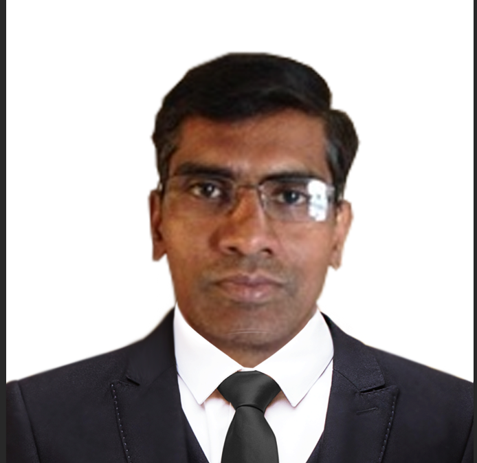 A man in a suit and tie is wearing glasses