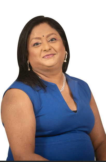 A woman in a blue top is smiling for the camera