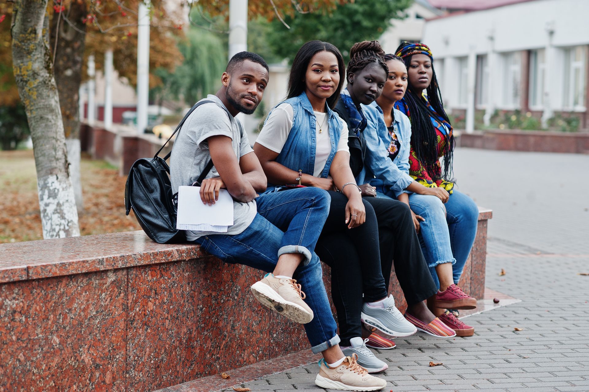 A group of young people are taking a selfie in a classroom.