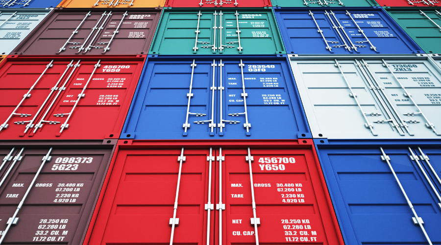 A bunch of colorful shipping containers are stacked on top of each other.