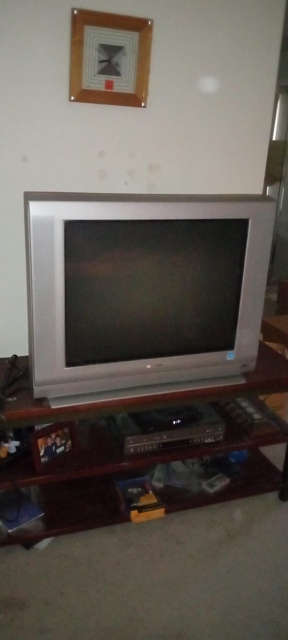 A flat screen tv is sitting on a wooden stand in a living room.
