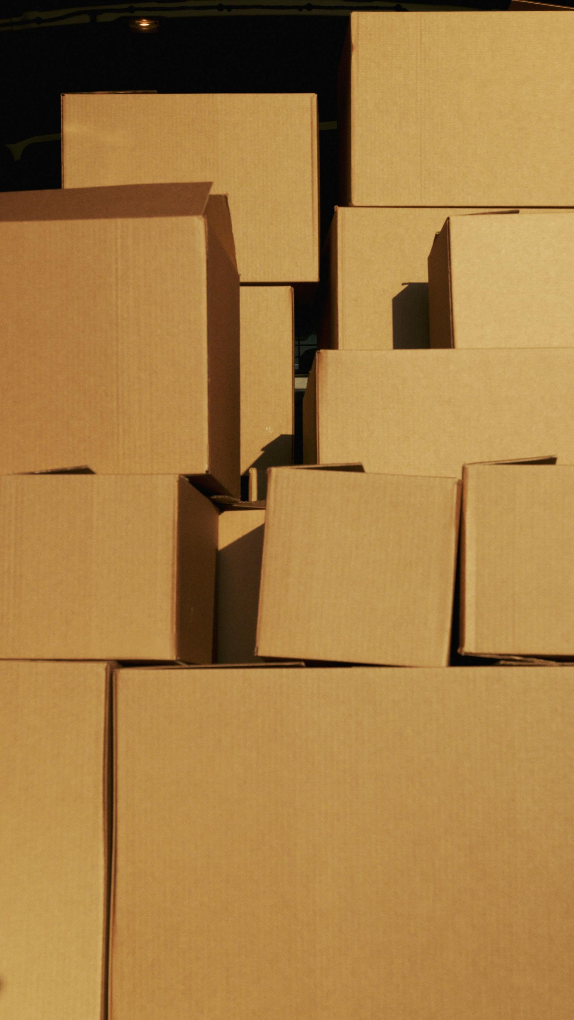 A pile of cardboard boxes stacked on top of each other Recycled.