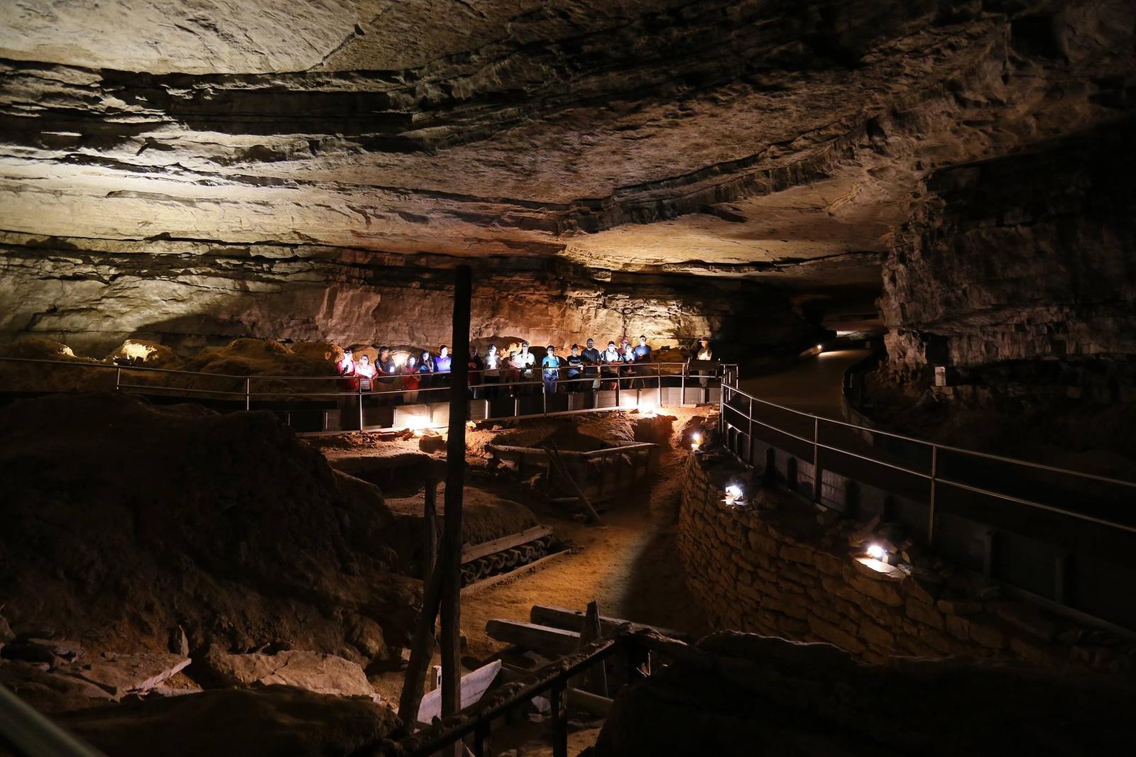 A group of people are standing in a cave.