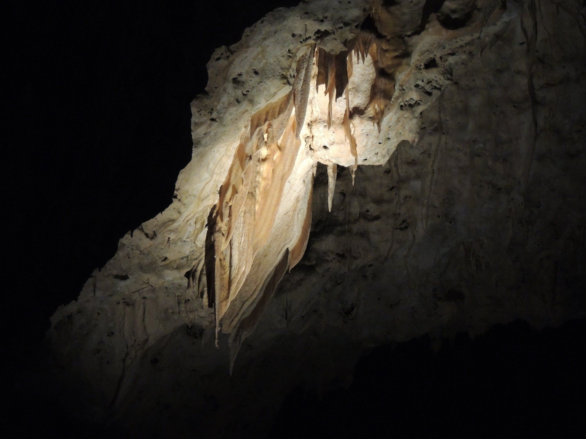 A cave with a lot of icicles hanging from the ceiling