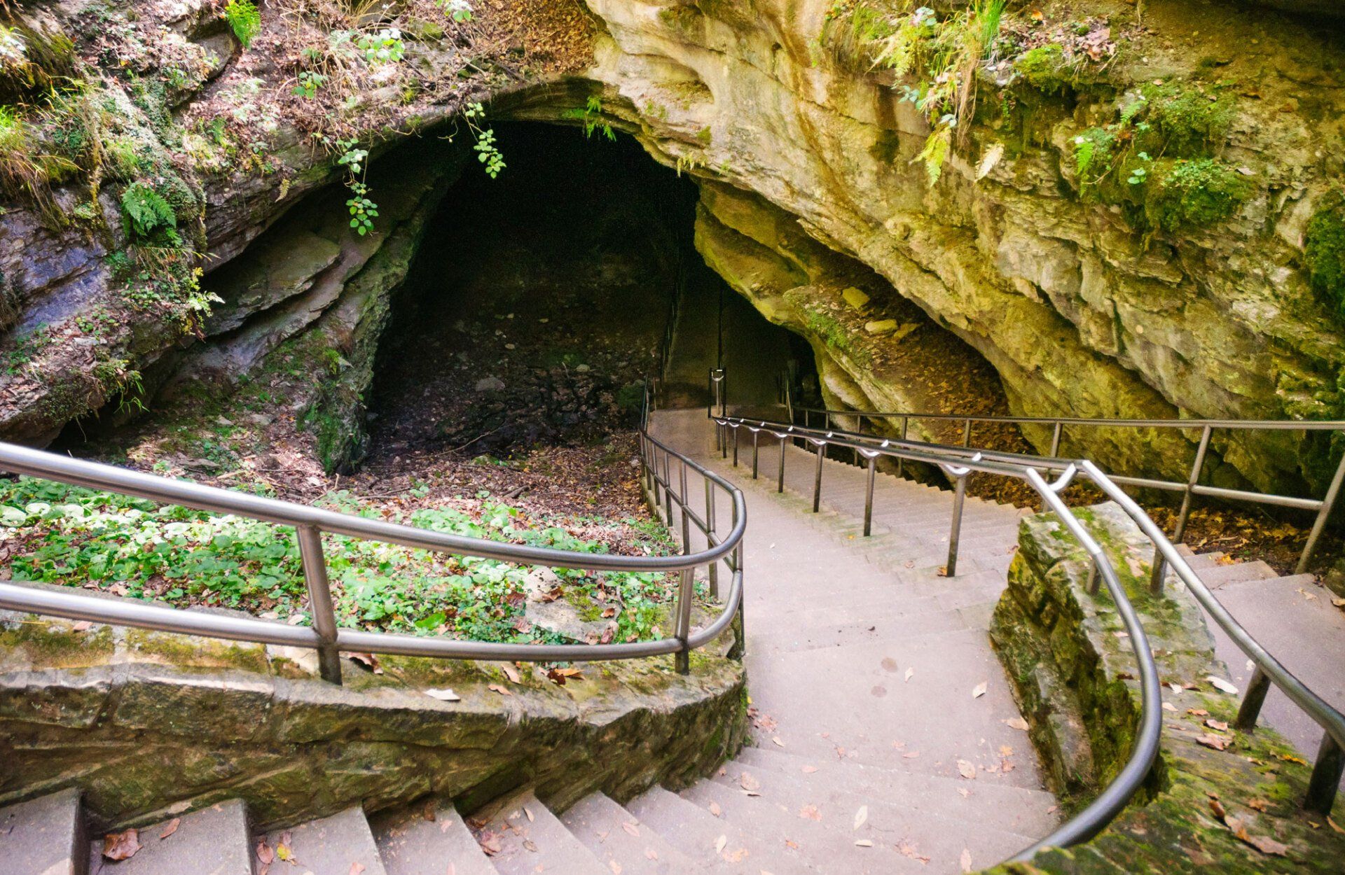 A set of stairs leading up to a cave.