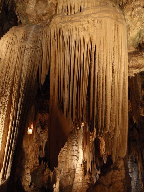 A cave with a lot of icicles hanging from the ceiling