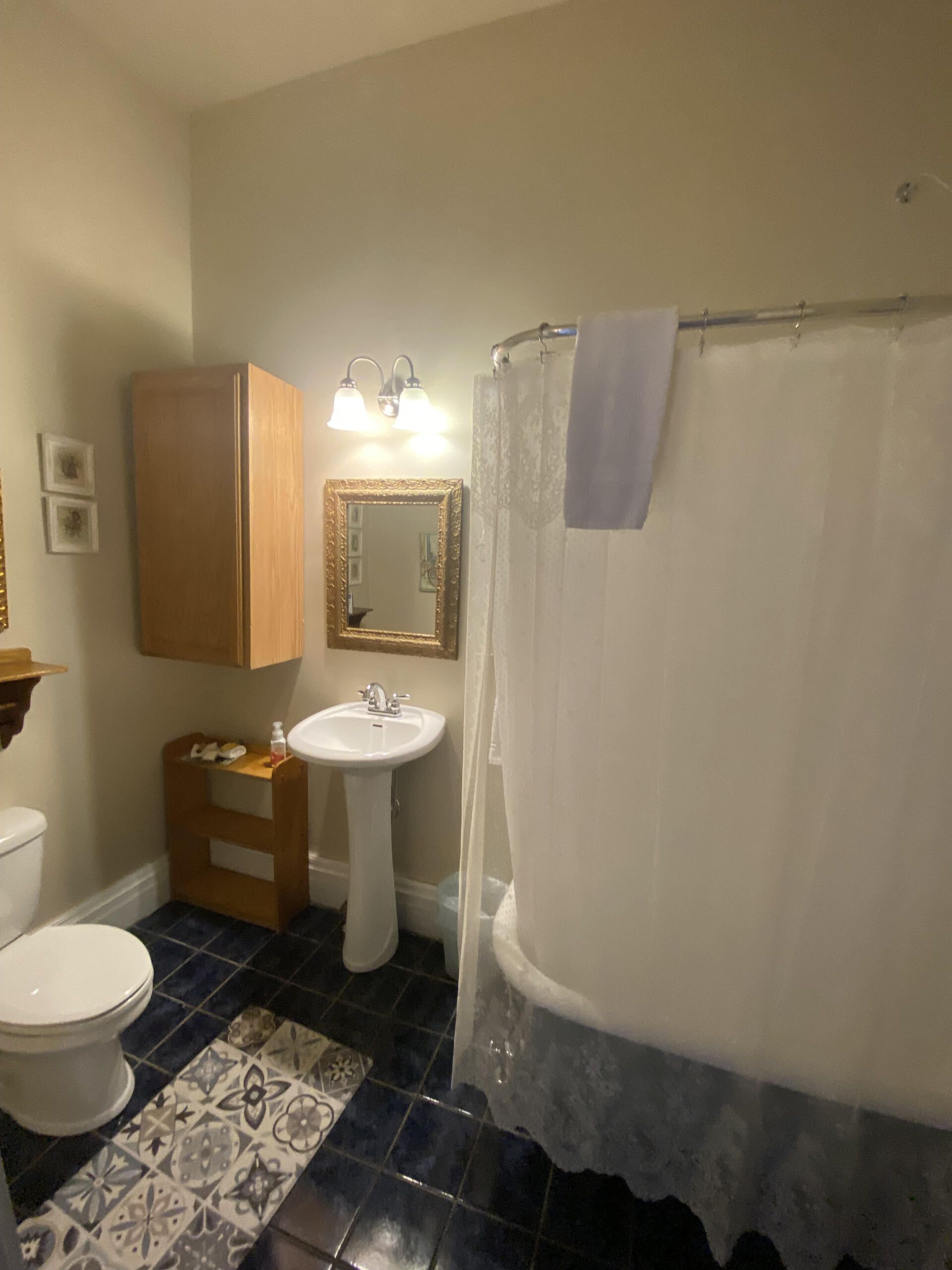 A bathroom with a toilet a sink and a bathtub