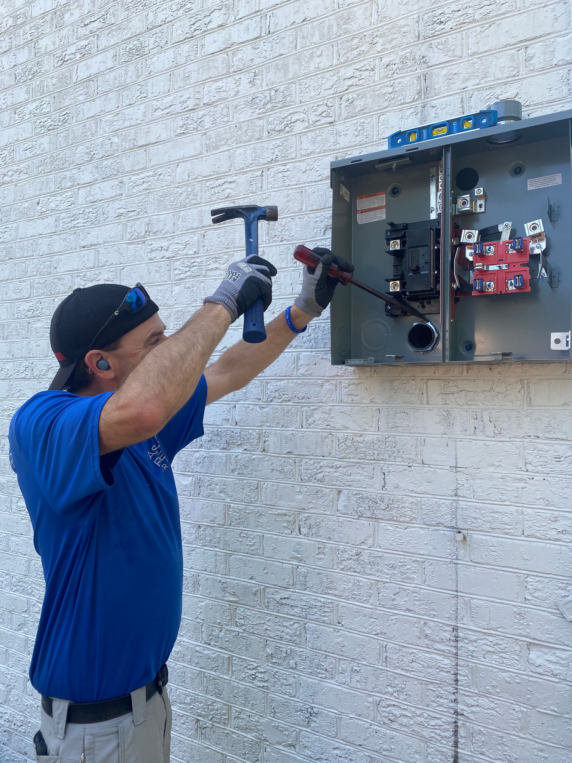 Licensed electrician evaluating a residential main electrical panel before installation in Charlesto