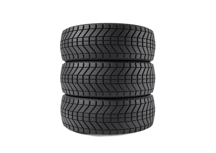 Stack of three black car tires on a white background