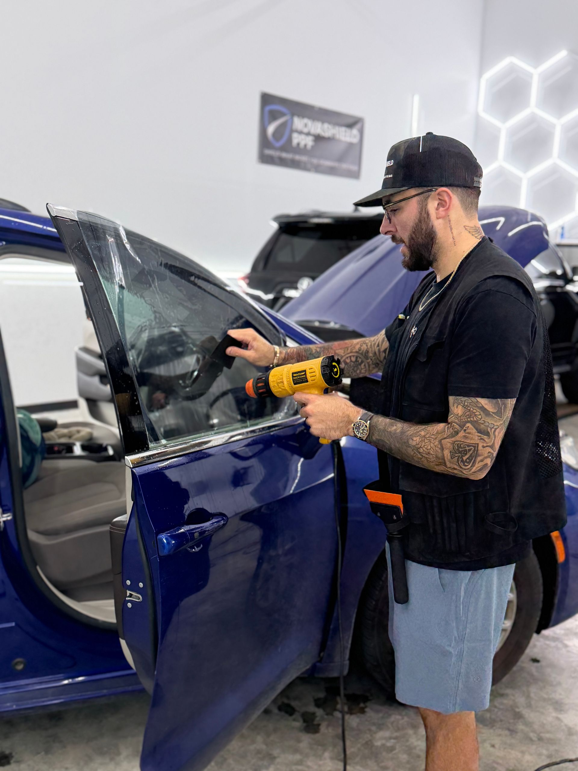 Person cleaning a car window with a cloth at a car wash