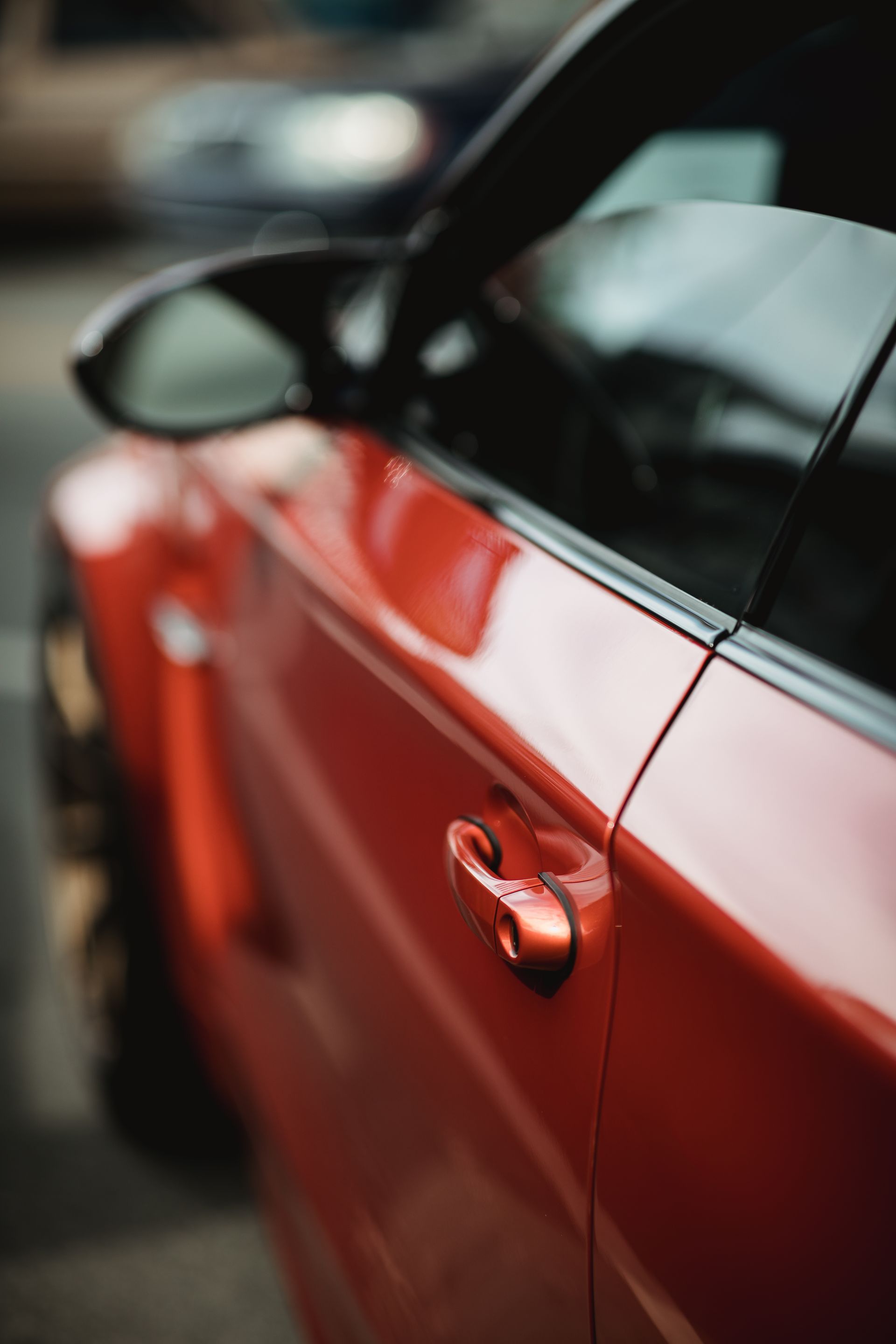 Red engine bay with a polished valve cover under an open car hood