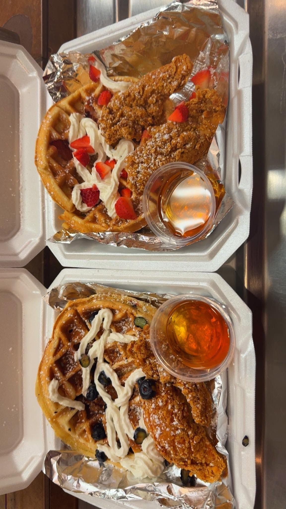 Two takeout containers of sauced noodle dishes with vegetables and a cup of dipping sauce