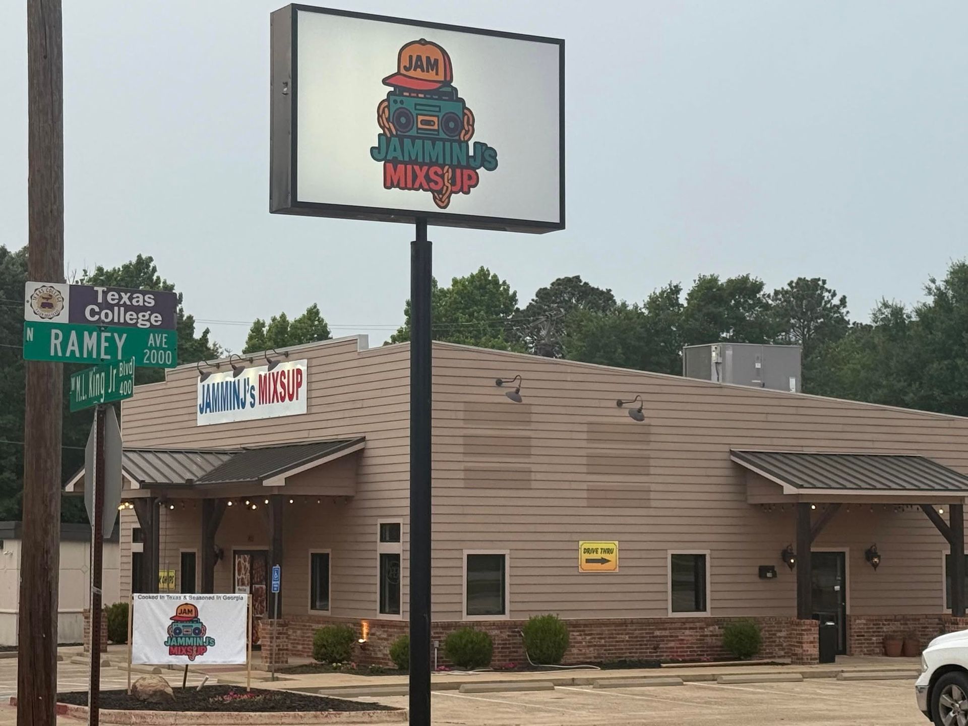Country Ham restaurant exterior with tan building, roadside signs, and a large sign on a pole.