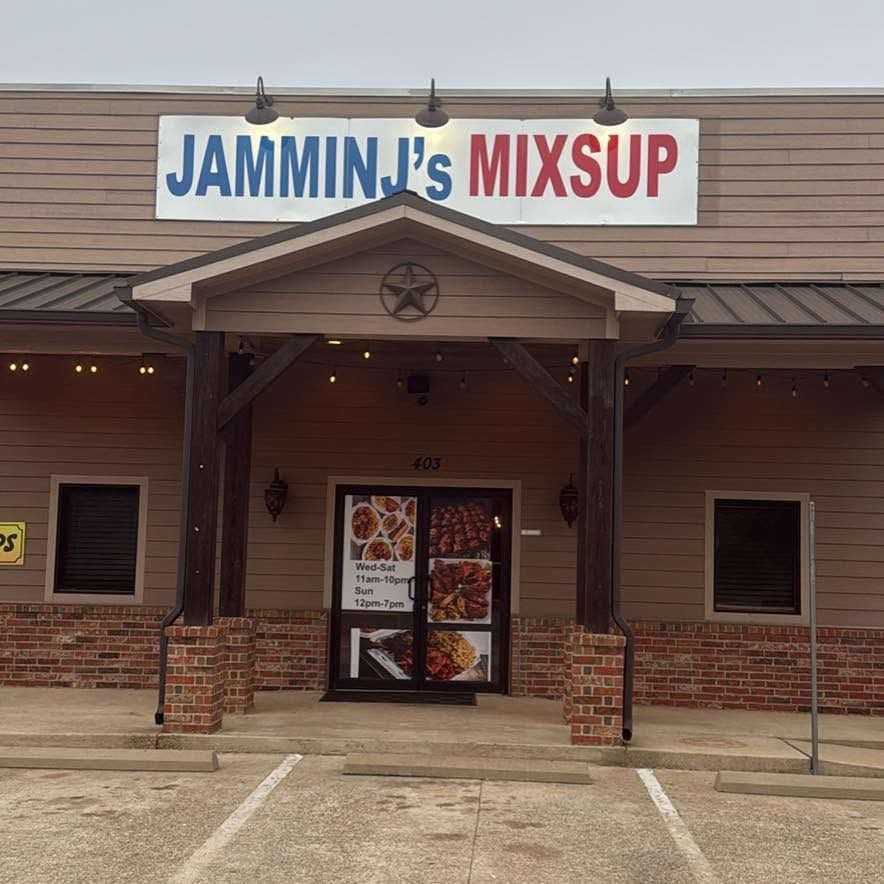 Storefront of JAMMIN' J's MIXUP with brick facade and covered entrance