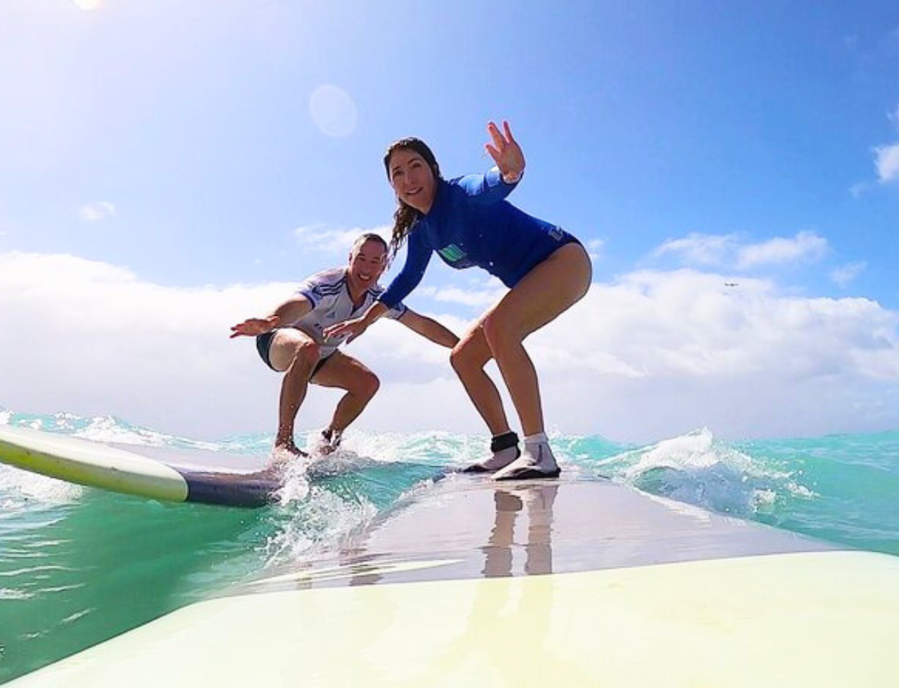 Couple enjoying a surfing experience in Cape Town in Muizenburg