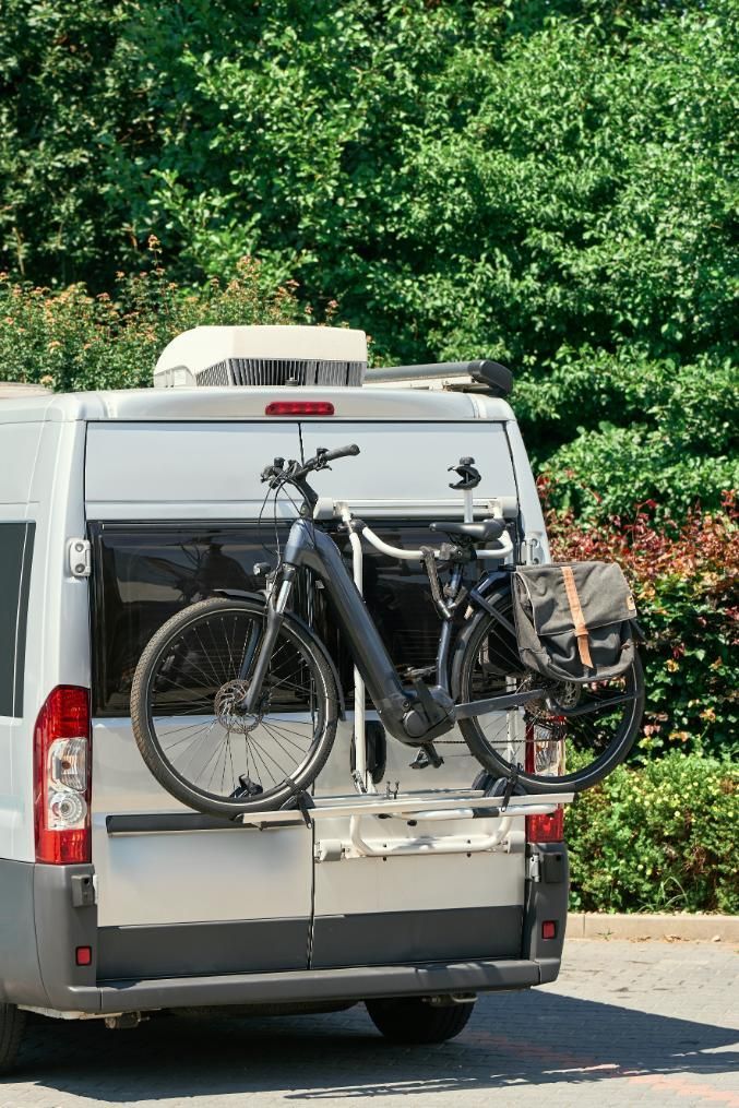 A Van With a Bicycle Attached to the Back of It — Lake Macquarie Caravan Repairs In Cardiff, NSW